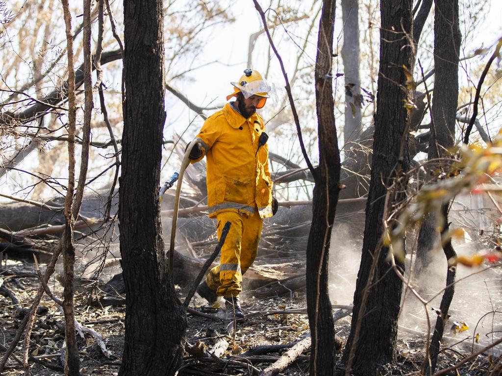 Firefighters are continuing to put out spot fires in the area. Picture: Nigel Hallett