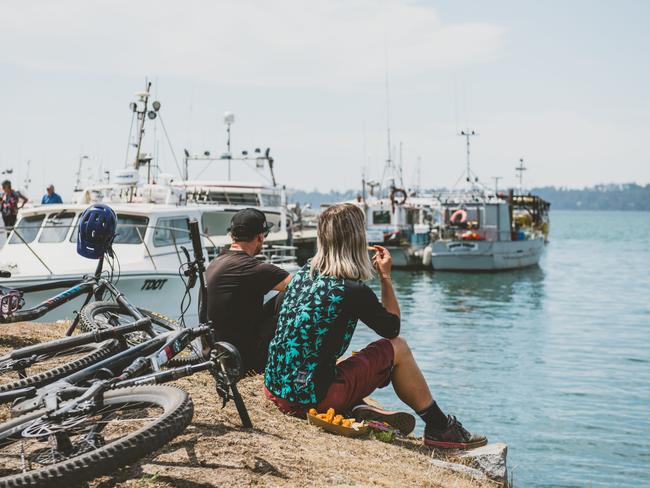 People eating fish and chips by the shore at St Helens, Tasmania. For TasWeekend summer edition. Picture: Stu Gibson