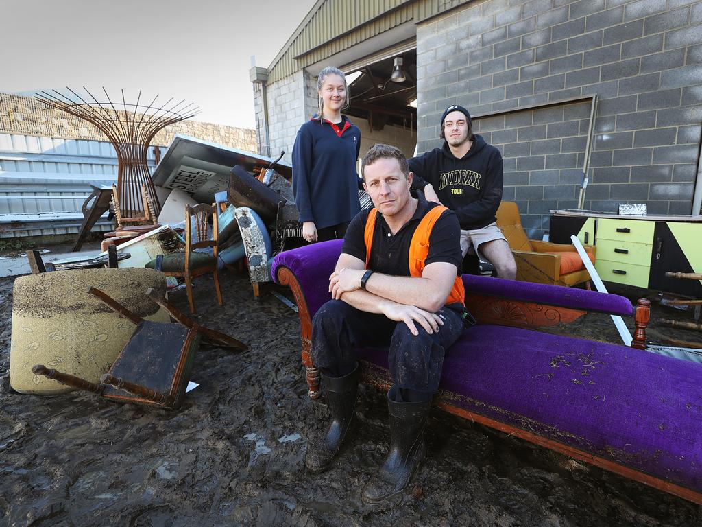 Owner of Retro Steel Furniture in South Hobart Jason Haas, centre, with his children Heather, 21, left, and Angus, 22 ,with damaged stock. Picture: SAM ROSEWARNE.