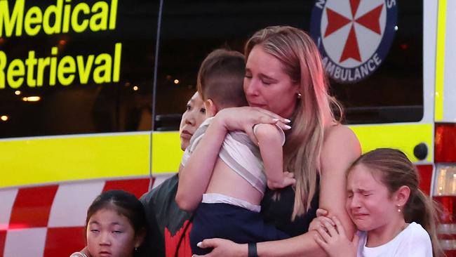 A family leaves the Westfield Bondi Junction shopping mall after a stabbing incident. Picture: David GRAY / AFP