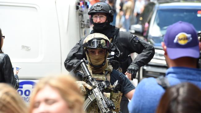 Heavily-armed officers patrol the streets. Picture: Lawrence Pinder