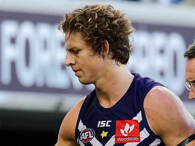 PERTH, AUSTRALIA - APRIL 07: Nat Fyfe of the Dockers is assisted off the field after sustaining a head knock the 2019 AFL round 03 match between the Fremantle Dockers and the St Kilda Saints at Optus Stadium on April 07, 2019 in Perth, Australia. (Photo by Will Russell/AFL Media/Getty Images)