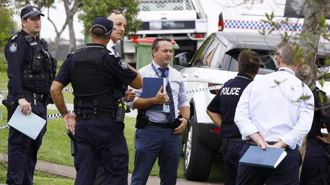 Police and detectives outside the house in Varsity Lakes where the body of a 81-year-old female was found. Picture: Tertius Pickard.