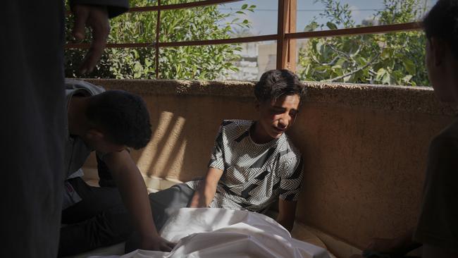 People mourn beside the body of someone killed while heading to a Gaza aid hub on June 3. Picture: AP