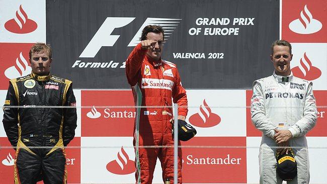 Kimi Raikkonen, Fernando Alonso and Michael Schumacher celebrate on the podium.