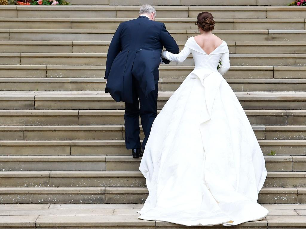 Britain's Princess Eugenie of York (R) accompanied by her father Britain's Prince Andrew, Duke of York, arrives for her wedding to Jack Brooksbank at St George's Chapel, Windsor Castle, in Windsor, on October 12, 2018. (Photo by TOBY MELVILLE / POOL / AFP)