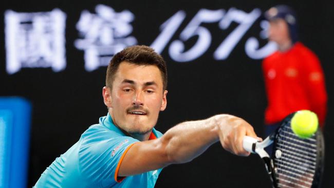 Australia's Bernard Tomic hits a return against Croatia's Marin Cilic during their men's singles match on day one of the Australian Open tennis tournament in Melbourne on January 14, 2019. (Photo by DAVID GRAY / AFP) / -- IMAGE RESTRICTED TO EDITORIAL USE - STRICTLY NO COMMERCIAL USE --