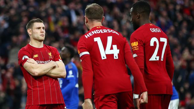 Liverpool’s James Milner celebrates with Jordan Henderson and Divock Origi after he scoring a late penalty against Leicester at Anfield. Picture: Getty Images