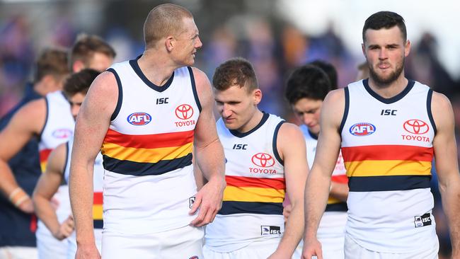 Sam Jacobs, Rory Laird and Brad Crouch of the Crows look dejected after losing the round 23 AFL match to the Western Bulldogs. Picture: Quinn Rooney/Getty Images