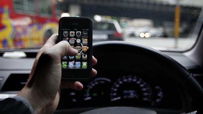 Judge Greg Macdonald said simply holding a mobile phone while driving, even without engaging in a phone call, constituted an offence under the law.