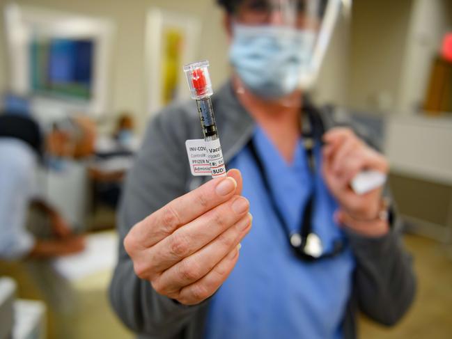 PITTSBURGH, PA - DECEMBER 17: Nurse Mary Catherine Klee holds a dose of the Pzifer COVID-19 vaccine before administering it to an employee of the Pittsburgh VA Medical Center on December 17, 2020 in Pittsburgh, Pennsylvania. The Pittsburgh VA Medical Center received a total of 975 initial doses of the vaccine to begin immunizing its frontline health workers and employees deemed most at-risk. Each employee immunized with the 1st dose will return in 21 days to receive the 2nd dose before complete immunization can be achieved.   Jeff Swensen/Getty Images/AFP == FOR NEWSPAPERS, INTERNET, TELCOS & TELEVISION USE ONLY ==