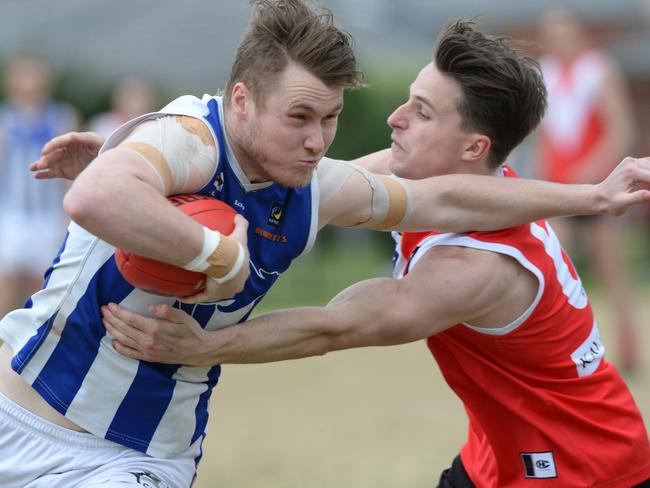 Langwarrin’s Jesse Murrphy is tackled by Red Hill’s James Fletcher. Picture: Chris Eastman