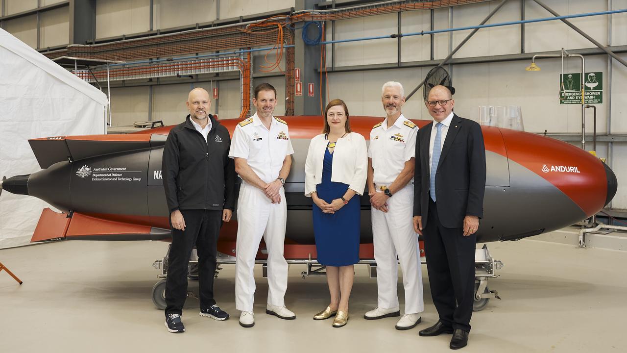 From left: Dr Shane Arnott, Anduril Australia’s Senior Vice President of Engineering and, effectively, chief designer of both the XL-AUV and the Boeing MQ-28A Ghost Bat; Rear Admiral Steve Hughes; Chief Defence Scientist Professor Tanya Monro AC; Rear Admiral Peter Quinn (retired); and David Goodrich OAM, CEO of Anduril Australia; stand in front of the Dive LD autonomous submarine which is much smaller but uses the same Lattice OS as the Ghost Shark and will be used by Defence for experimentation, testing and validation as it develops the Ghost Shark.