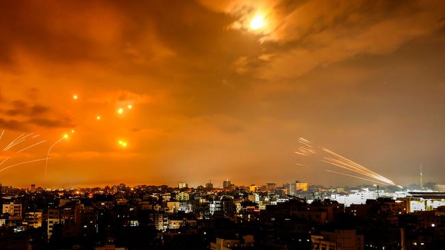 Rockets fired by Palestinian militants from Gaza City are intercepted by the Israeli Iron Dome defence missile system in the early hours of October 8.