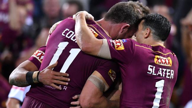 Billy Slater (right) of the Maroons celebrates the try of Valentine Holmes with Gavin Cooper.