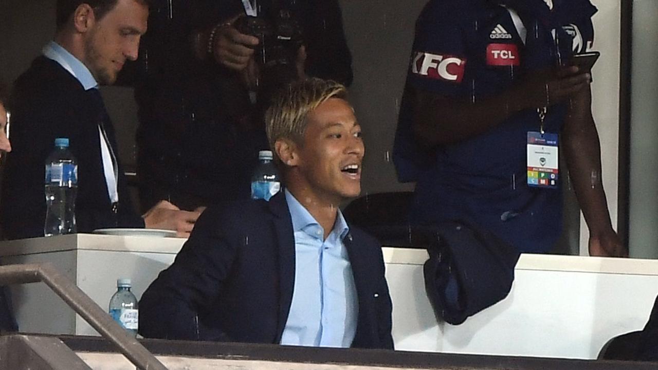 Keisuke Honda (fourth left) is seen in the grandstand. (AAP Image/Julian Smith) 
