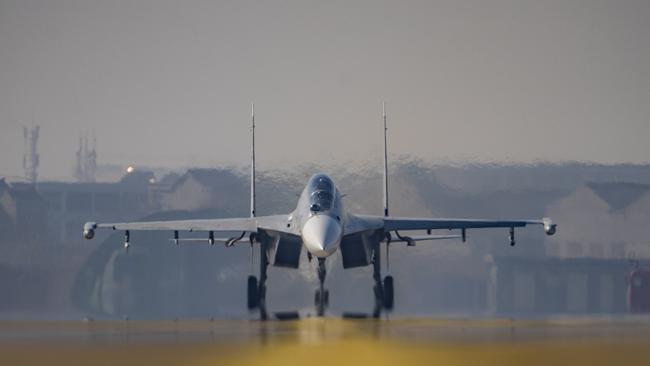 A J-16 air fighter waits to take off on the runway at a training base of the PLA's naval aviation force in Ningbo in east China. Picture: Getty Images.