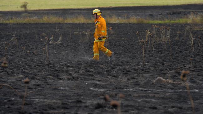 A firefighter at the scene of the grass fire behind Rowell Place in Taylors Lakes on January 11, 2021. Picture: Josie Hayden