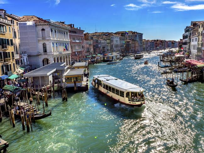 Colorful Grand Canal Public Ferries Vaporetto Ferry Docks Gondola From Rialto Bridge Touirists Grand Canal Venice Italy.Picture: iStockTravel trends, Lisa Mayoh, Escape