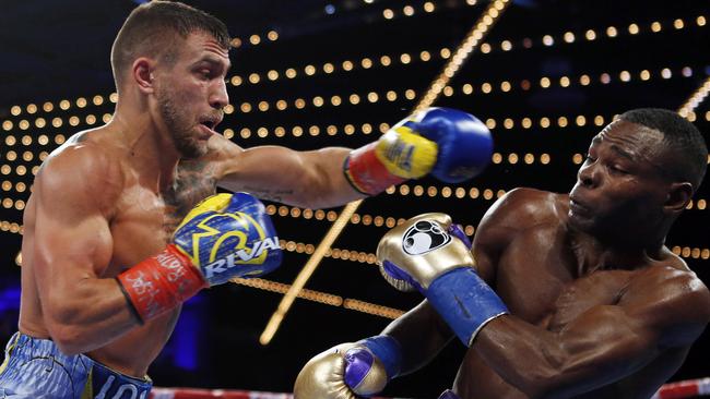 Vasyl Lomachenko punches Guillermo Rigondeaux during the third round of a WBO junior lightweight title boxing match.