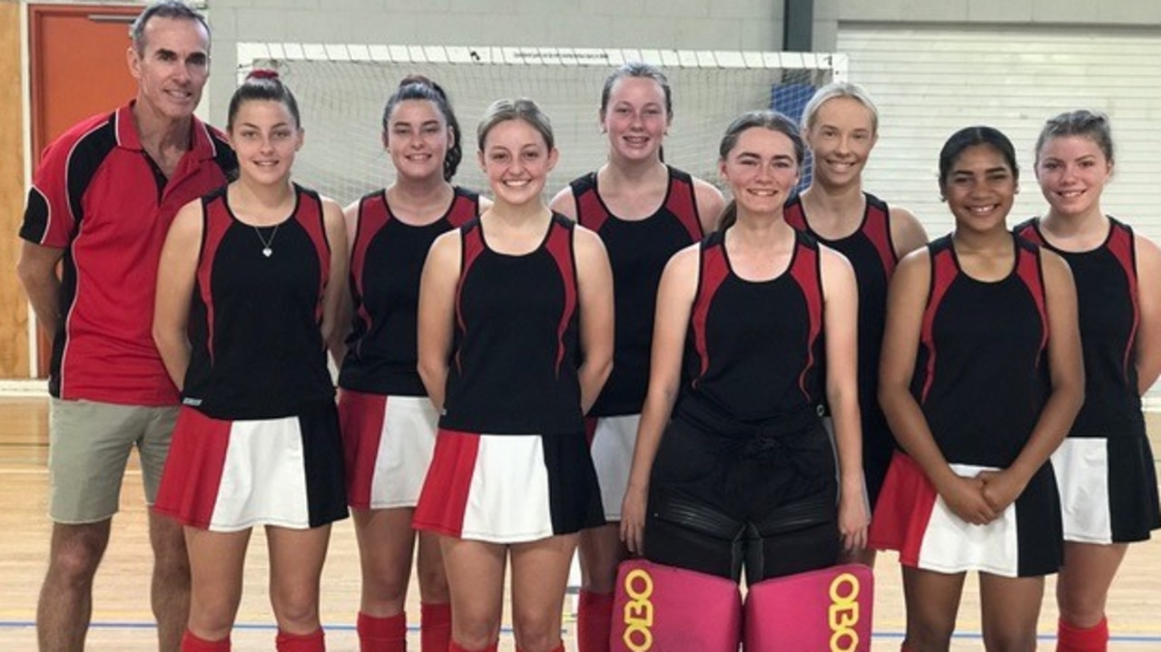 Robert Sweeney with the Rockhampton under-18 girls indoor hockey team that he coached in 2019.