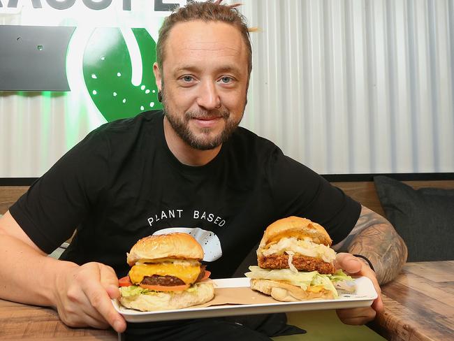 Owner of Grassfed Johnny Garrison with some of the burgers that keep herbivores and carnivores coming back for more. Picture: AAP/Jono Searle