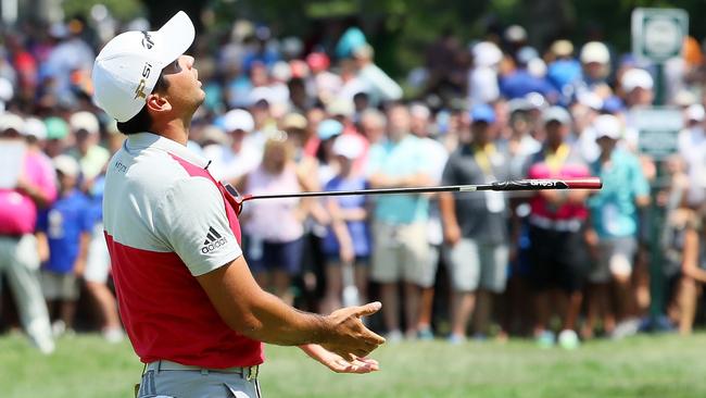Jason Day shows his frustration after another close miss on the greens.