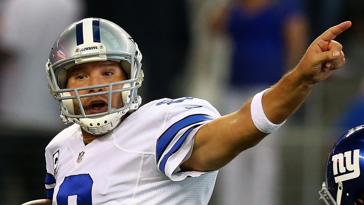 ARLINGTON, TX - OCTOBER 19: Tony Romo #9 of the Dallas Cowboys signals to a reciever as Mike Patterson #93 of the New York Giants applies pressure in the second half at AT&T Stadium on October 19, 2014 in Arlington, Texas. Ronald Martinez/Getty Images/AFP == FOR NEWSPAPERS, INTERNET, TELCOS & TELEVISION USE ONLY ==