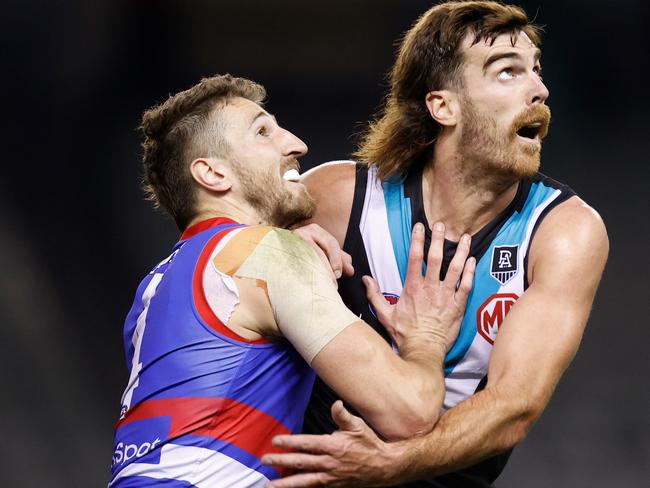 MELBOURNE, AUSTRALIA - AUGUST 20: Marcus Bontempelli of the Bulldogs and Scott Lycett of the Power compete in a ruck contest during the 2021 AFL Round 23 match between the Western Bulldogs and the Port Adelaide Power at Marvel Stadium on August 20, 2021 in Melbourne, Australia. (Photo by Michael Willson/AFL Photos via Getty Images)