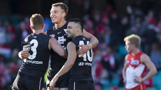 Marc Murphy, Patrick Cripps and Michael Gibbons celebrate the Blues win at the SCG. Picture: AAP