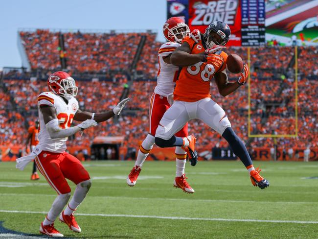 Wide receiver Demaryius Thomas #88 of the Denver Broncos has a second quarter 12 yard touchdown catch under coverage by free safety Husain Abdullah #39 of the Kansas City Chiefs and cornerback Chris Owens #20.
