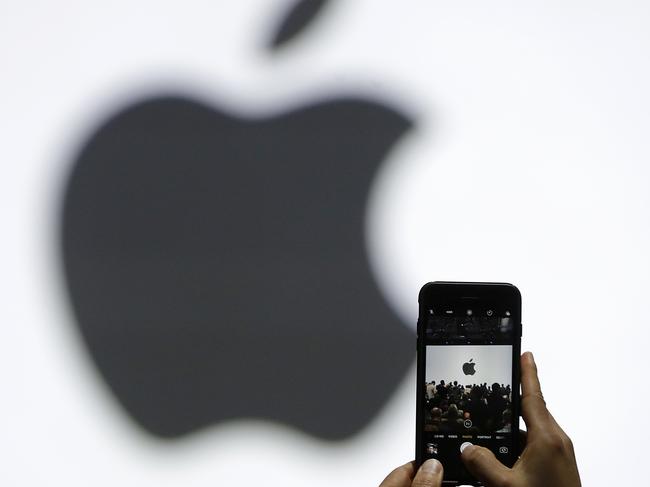 FILE - In this Monday, June 5, 2017, file photo, a person takes a photo of an Apple logo before an announcement of new products at the Apple Worldwide Developers Conference in San Jose, Calif. Apple is expected to demand $1,000 for the fanciest iPhone that it has ever made, thrusting the market into a new financial frontier that will test how much consumers are willing to pay for a device that has become an indispensable part of modern life. (AP Photo/Marcio Jose Sanchez, File)