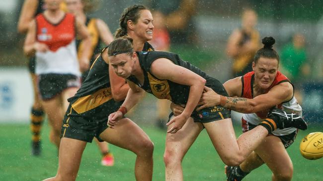 Glenelg’s Tamsyn Morriss tries to escape a tackle by The NT’s Lauren Gooden during the NTFL Women v Glenelg women match at TIO Stadium last month. Picture: Glen Campbell