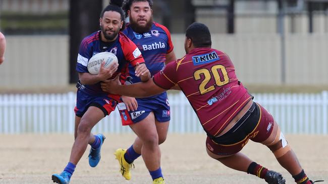 Viliame Saukuru for Campbelltown Collegians runs around Peter Maotaane. Picture: Steve Montgomery