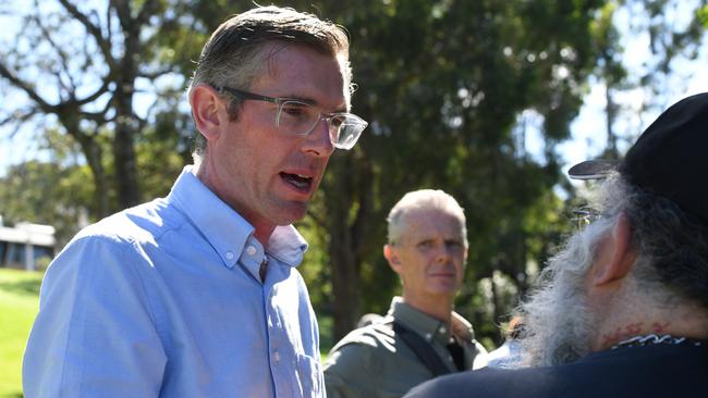 Premier Dominic Perrottet discussing river peak heights with Lismore councillor Big Rob at Southern Cross University. Picture Cath Piltz