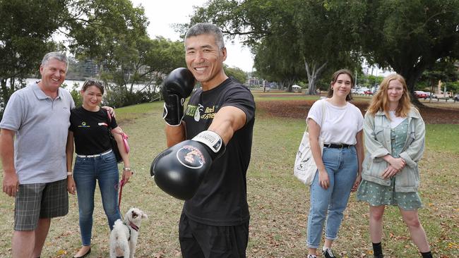 Troy Rolley and Bec Baker with their dog Izzy, Dundee Kim (centre) and Louisa Voogt and Caitlin Smollett at South Brisbane. Picture: Annette Dew