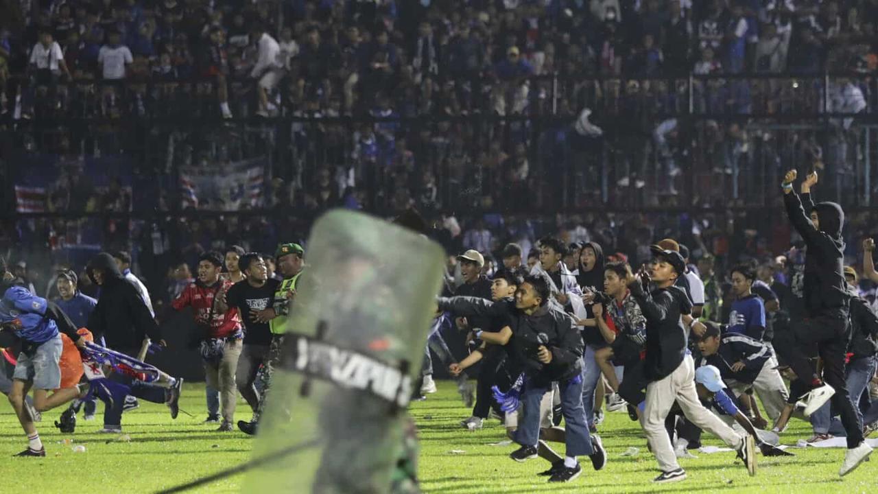 At least 174 people, including two police officers, have been killed in a stampede triggered by the use of tear gas to quell unrest after an Indonesian league football match in East Java on Sunday.