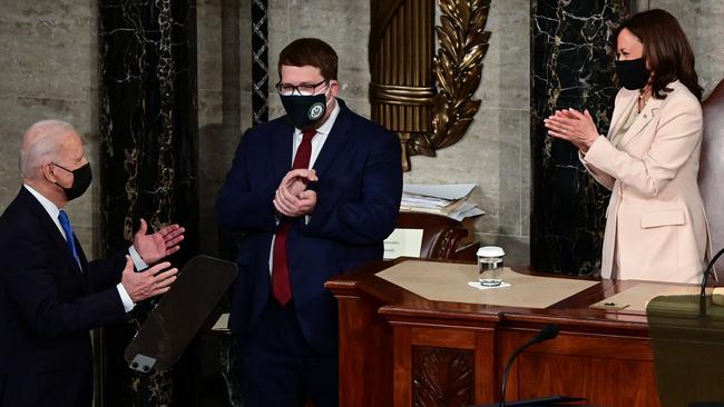 Joe Biden is applauded by US Vice President Kamala Harris (R) as he arrives to address a joint session of Congress. Picture: AFP.