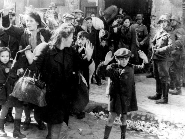 German troops lead Jewish civilians from the ghetto to their execution.