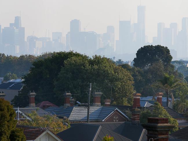 Hazy weather envelopes Melbourne's skyline as seen from High Street in Northcote. Picture : Ian Currie