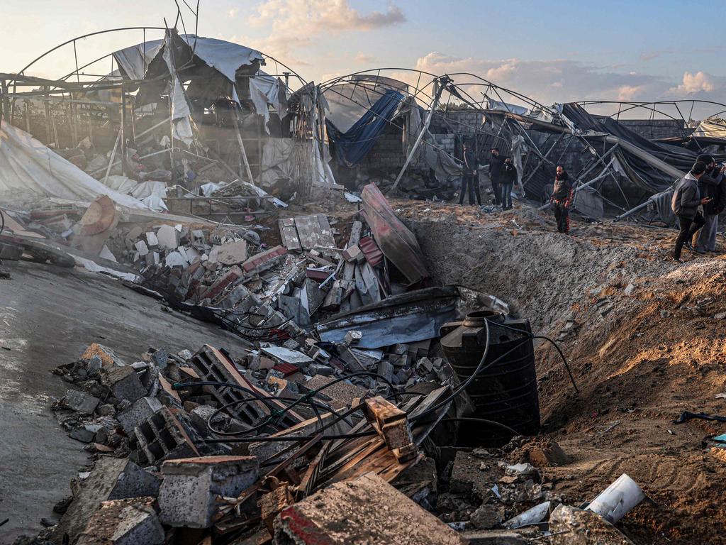 Palestinians inspect debris and rubble of a destroyed building following Israeli bombardments in Rafah in the southern Gaza Strip on February 19. (Photo by SAID KHATIB / AFP)