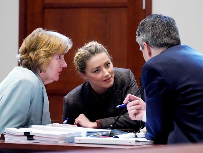 Amber Heard talks to her legal team in the courtroom. Picture: AFP