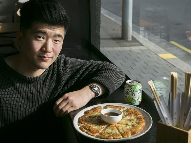 Kalbi owner Simon Park Owner with one of their tasty, light and crispy Seafood Pa Dxze pancakes, complete with vinegary, soy dip. Photograph EDDIE SAFARIK