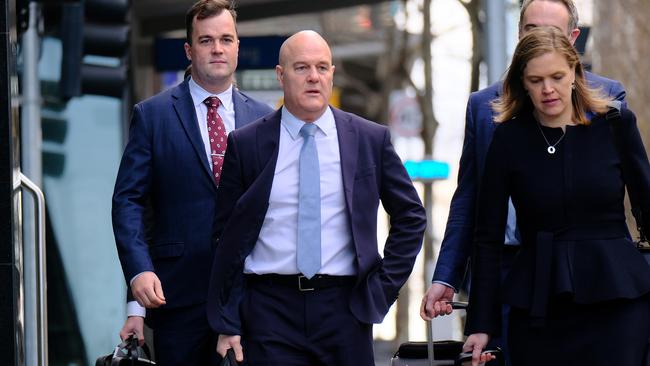 Crown Melbourne chief executive Xavier Walsh, centre, arrives at the commission hearing in Melbourne on Monday. Picture: AAP