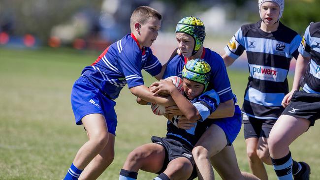Day One of King of the Country rugby tournament at James Overell Park, Southport. Maroochydore Swans U14s' Andy Bailey in action against USQ Saints U14s (blue white small stripes). Picture: Jerad Williams