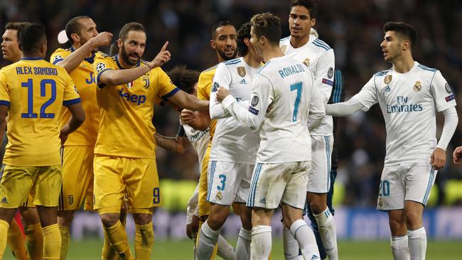 Real Madrid's Cristiano Ronaldo argues with Juventus' Gonzalo Higuai