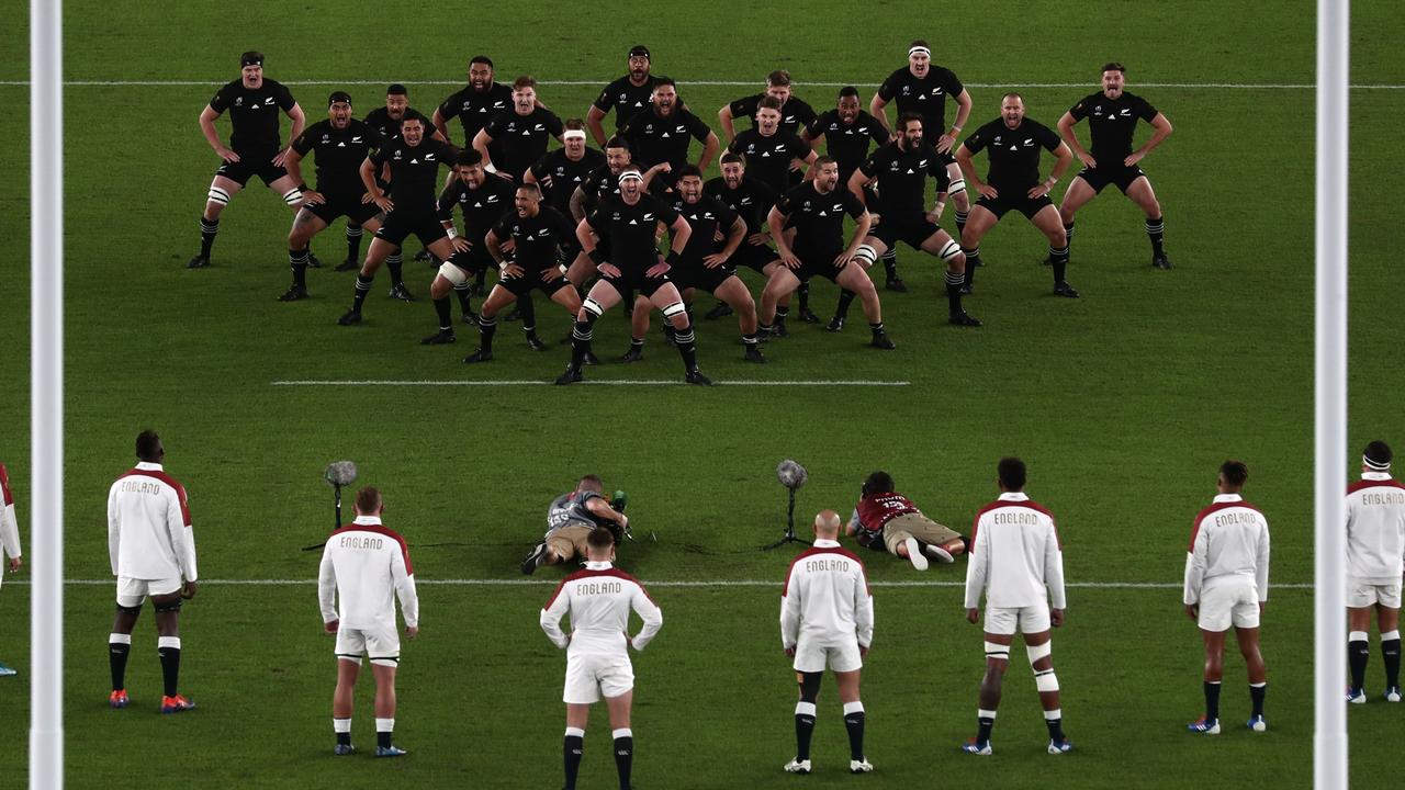 England players stand ina V-formation in response to the Haka.