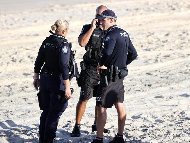 Police officers at The Spit, where a man drowned despite the best efforts of a lifesaver and paramedics to revive him. Picture: Nigel Hallett