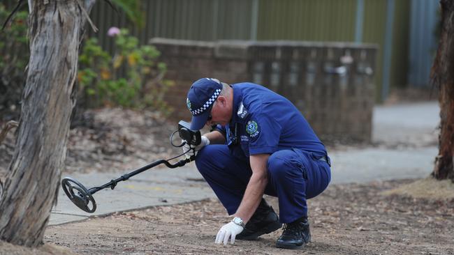 Police hunt for clues at the scene of the Dry Creek ambush.