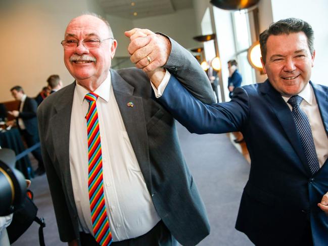 CORRECTION - Liberal Member of Parliament Warren Entsch (L) and Senator Dean Smith celebrate after parliament passed the same-sex marraige bill in the Federal Parliament in Canberra on December 7, 2017.  Gay couples will be able to legally marry in Australia after a same-sex marriage bill sailed through parliament on December 7, ending decades of political wrangling. / AFP PHOTO / SEAN DAVEY / “The erroneous mention[s] appearing in the metadata of this photo by SEAN DAVEY has been modified in AFP systems in the following manner: [Senator Dean Smith] instead of [Member of Parliament Dean Smith]. Please immediately remove the erroneous mention[s] from all your online services and delete it (them) from your servers. If you have been authorized by AFP to distribute it (them) to third parties, please ensure that the same actions are carried out by them. Failure to promptly comply with these instructions will entail liability on your part for any continued or post notification usage. Therefore we thank you very much for all your attention and prompt action. We are sorry for the inconvenience this notification may cause and remain at your disposal for any further information you may require.”